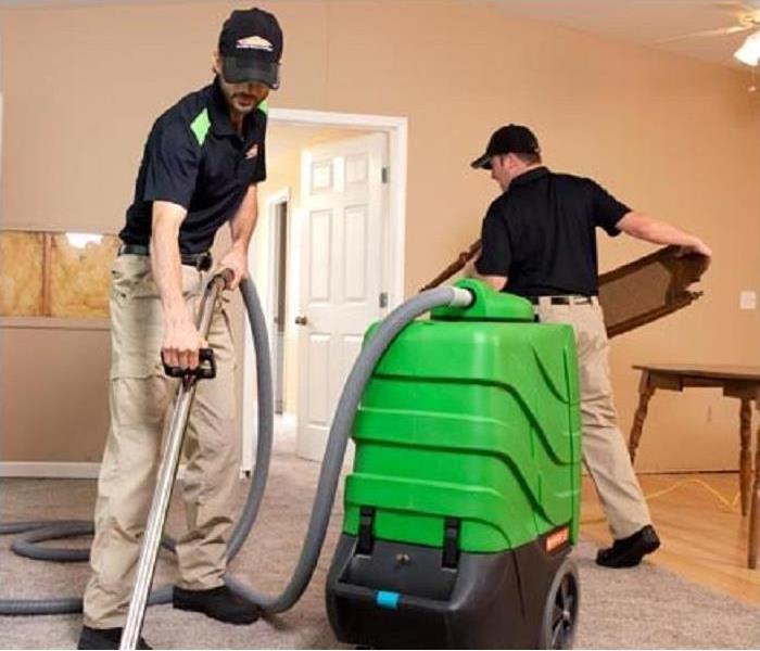 SERVPRO professionals cleaning a carpet. 