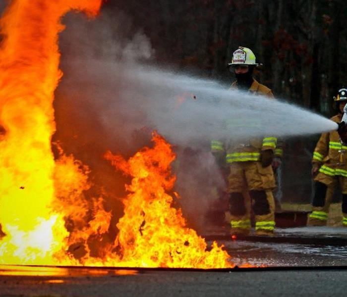 A fire being put out by a team of professionals.