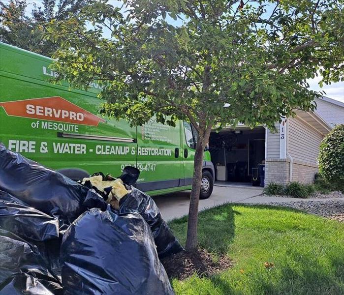 Servpro van parked in front of a home.