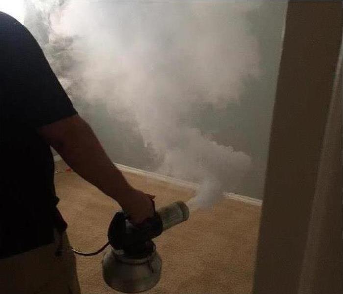 SERVPRO professional fogging a room.
