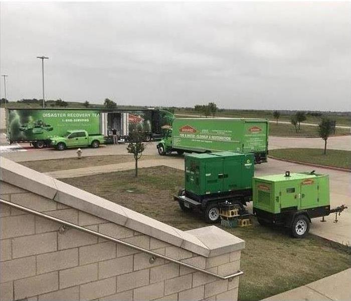 Servpro vehicles at a large commercial building that had a water loss